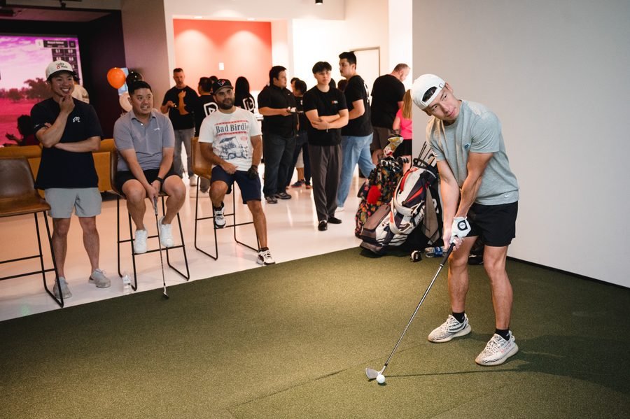 League players watching a putting contest at Birdie Central